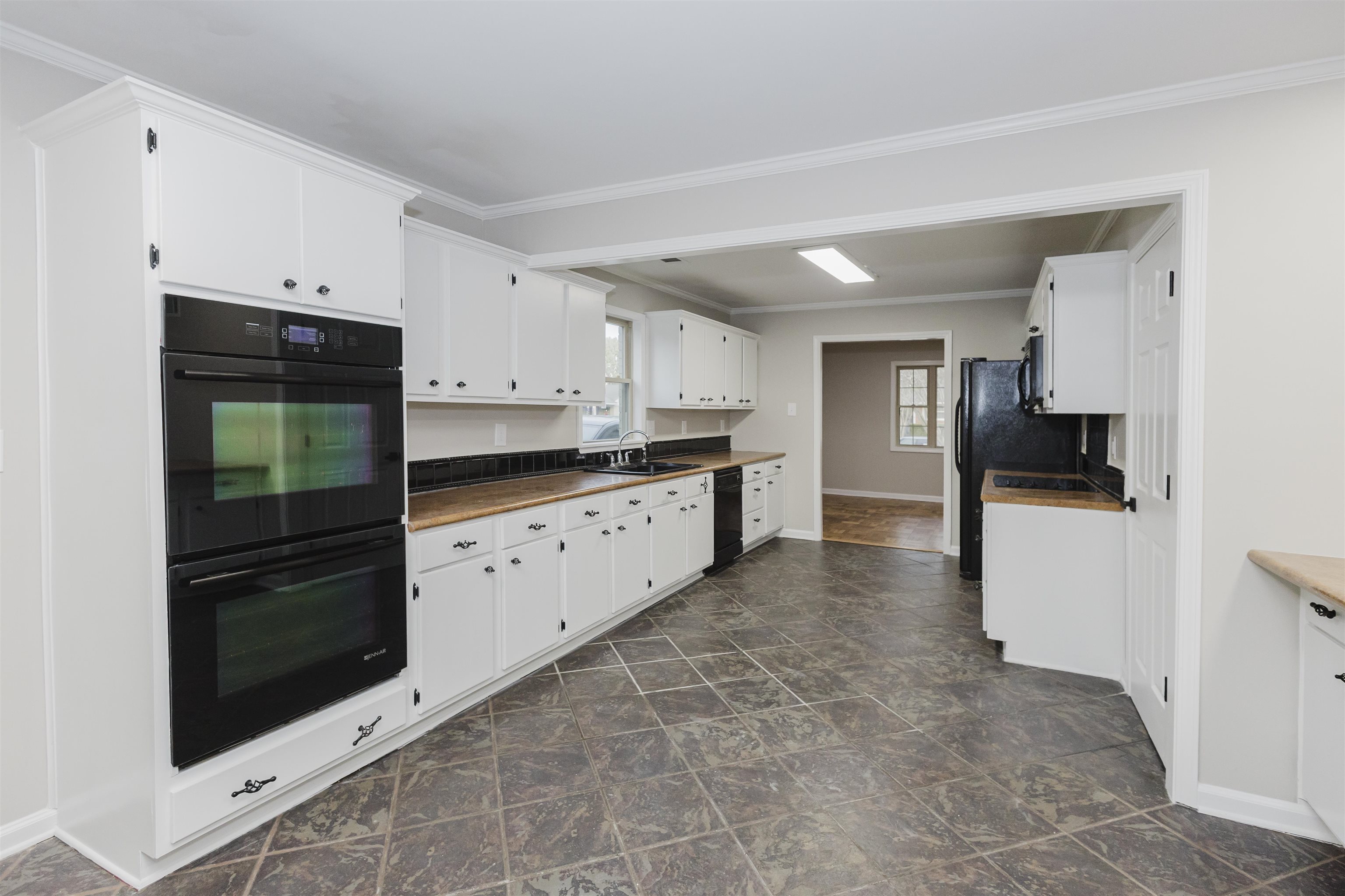 421 McDermitt Road Memphis, TN 38120 - Photo 10 of 23 a kitchen with granite countertop white cabinets and refrigerator