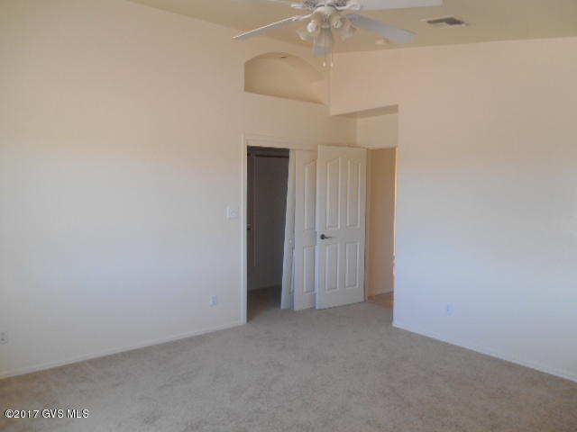 114 Circulo Penjamo Rio Rico, AZ 85648 - Photo 9 of 16 an empty room with a chandelier fan