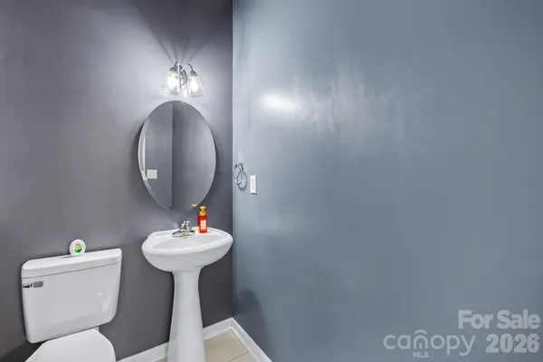 a bathroom with a sink mirror and toilet