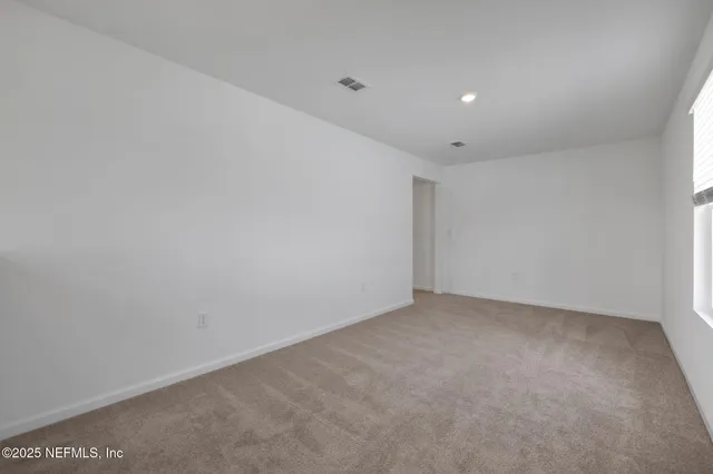 a view of an empty room and a window