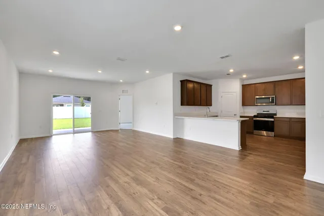 a view of a kitchen with a sink and a refrigerator