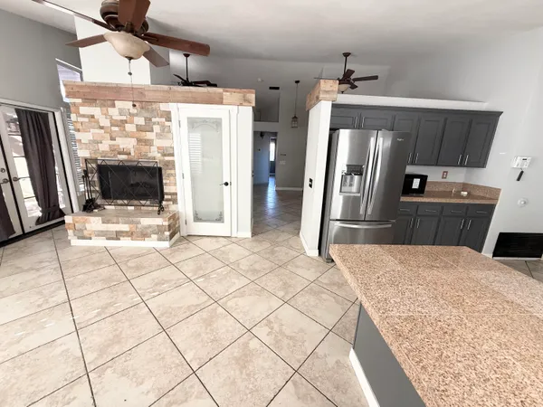 a kitchen with stainless steel appliances kitchen island granite countertop a refrigerator and a stove