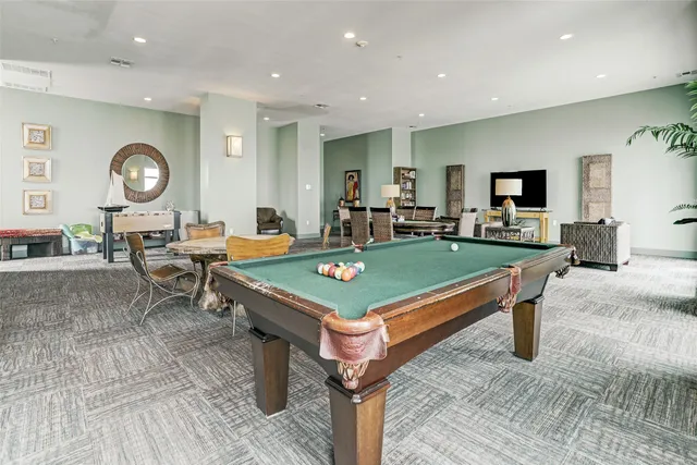 a living room with a table and a fireplace