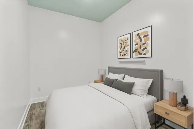 a bedroom with a bed and a wall painting