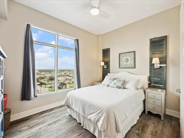 a bedroom with a large bed and a large window