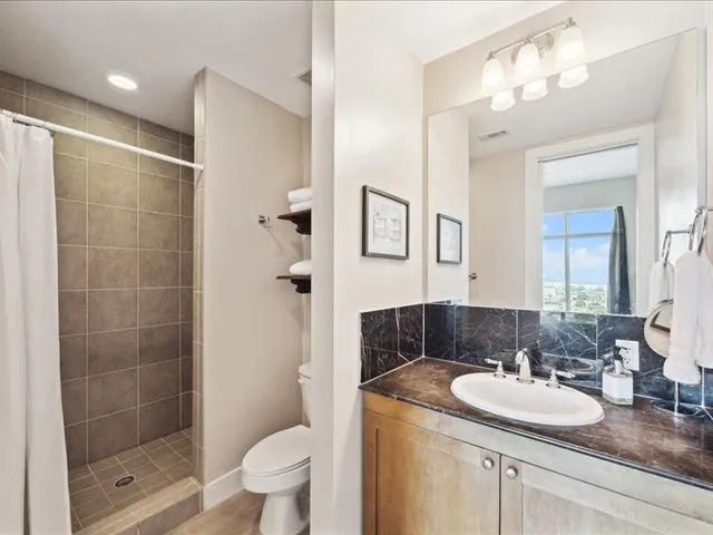 a bathroom with a sink toilet and shower