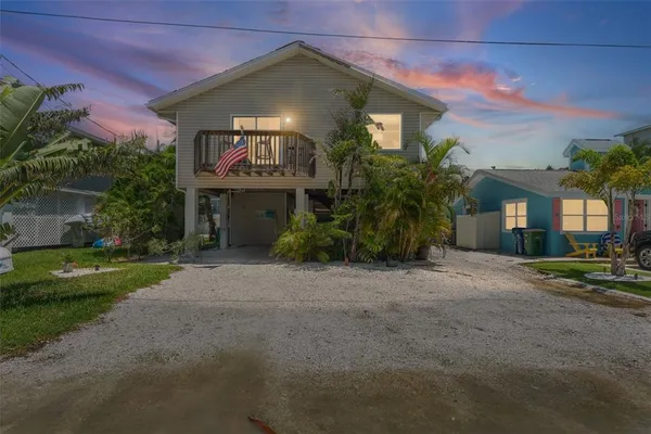 a front view of a house with a yard and a garage