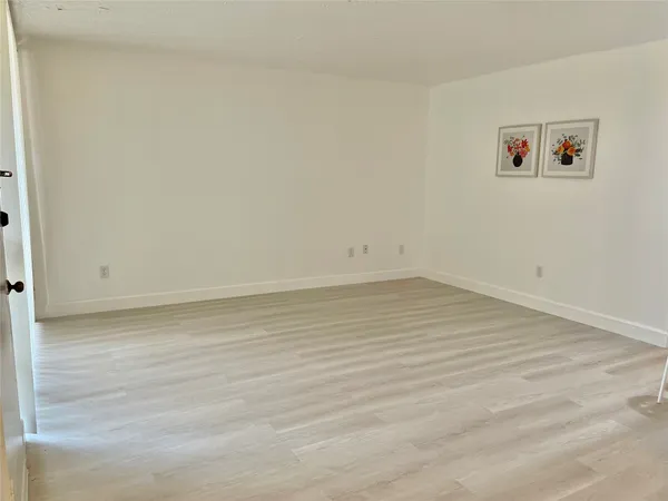a view of a room with wooden floor