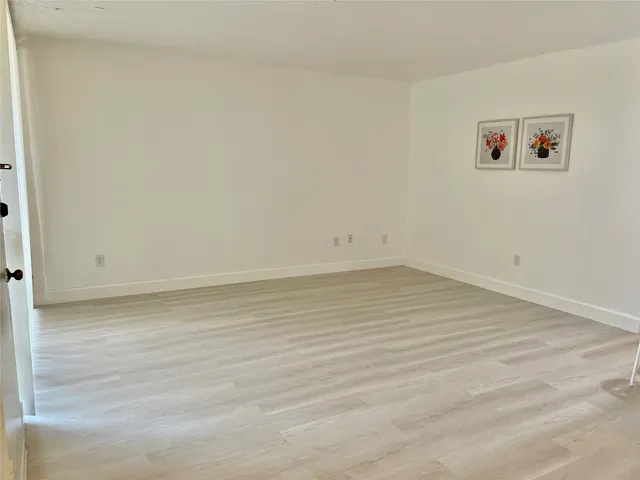 a view of a room with wooden floor