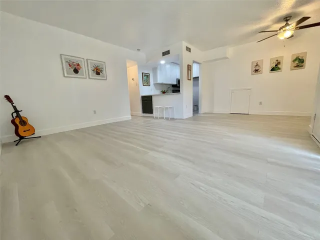 a view of a kitchen with a sink and a refrigerator