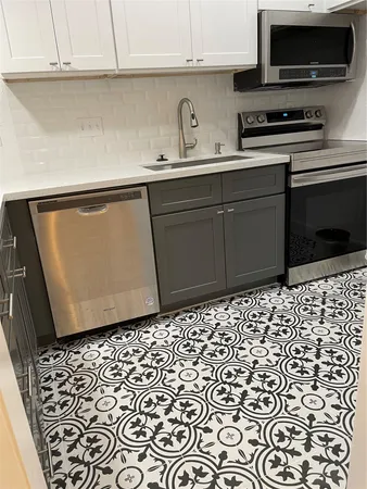 a kitchen with a sink and a stove
