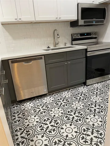 a kitchen with a sink and a stove