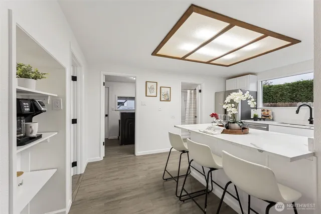 a view of a dining room with furniture and window