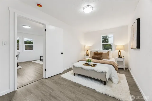 a spacious bedroom with a bed and a window