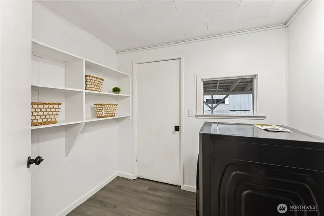 a view of empty room with closet and wooden floor