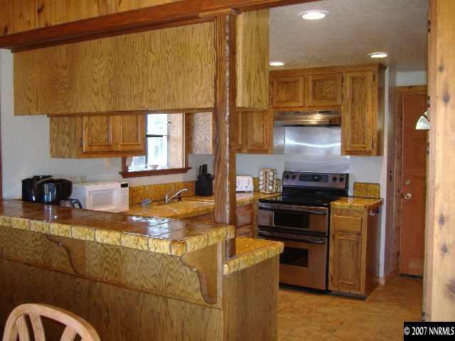 373 Maryanne Stateline, NV 89449 - Photo 4 of 9 a kitchen with a stove and a refrigerator