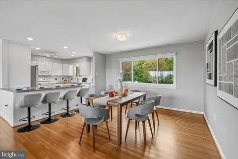 a kitchen with a table chairs stove and cabinets