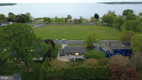 an aerial view of a house with a yard lake lake view and mountain view