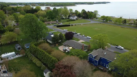 an aerial view of a house with a yard basket ball court and outdoor seating
