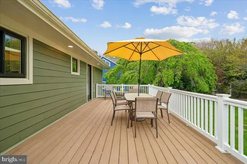 a view of a swimming pool with lawn chairs under an umbrella