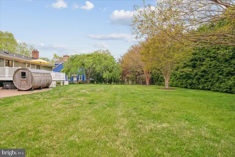 a car parked in front of a brick house next to a yard