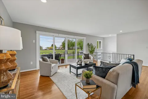 a living room with furniture and floor to ceiling windows