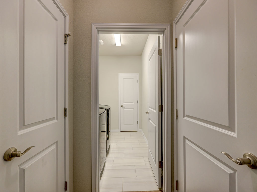 229 Heartleaf Road San Marcos, TX 78666 - Photo 31 of 40 Functional laundry space with easy access, featuring durable flooring and essential appliances.