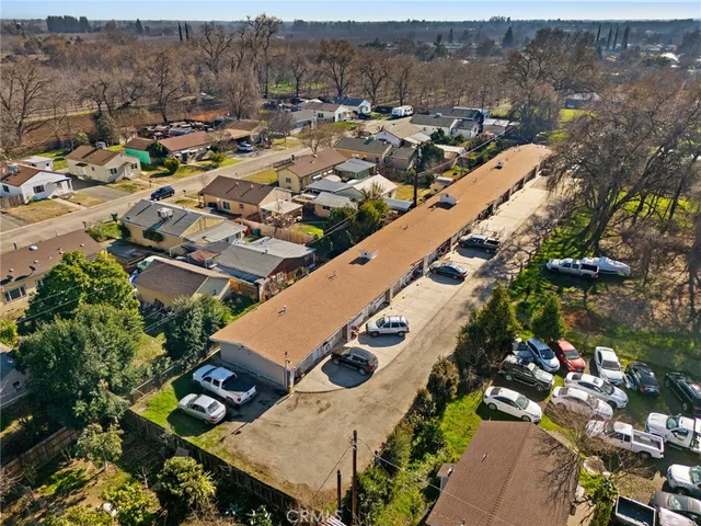 an aerial view of multiple houses with yard