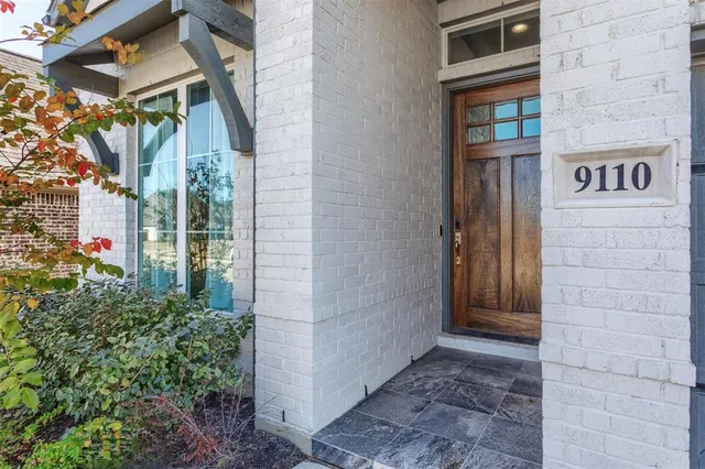a view of a brick house with many windows