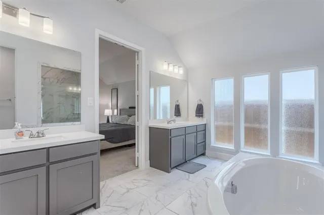 a bathroom with a bathtub and shower