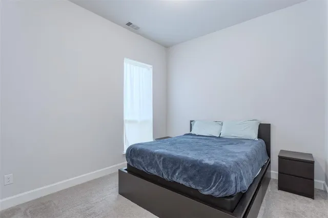 a bedroom with a bed and a cabinets