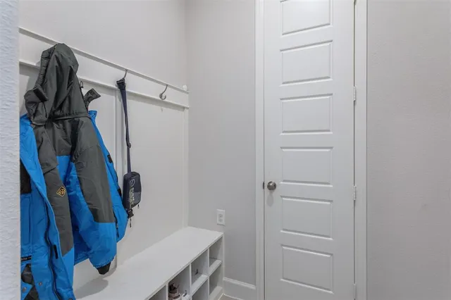 a view of walk in closet with clothes