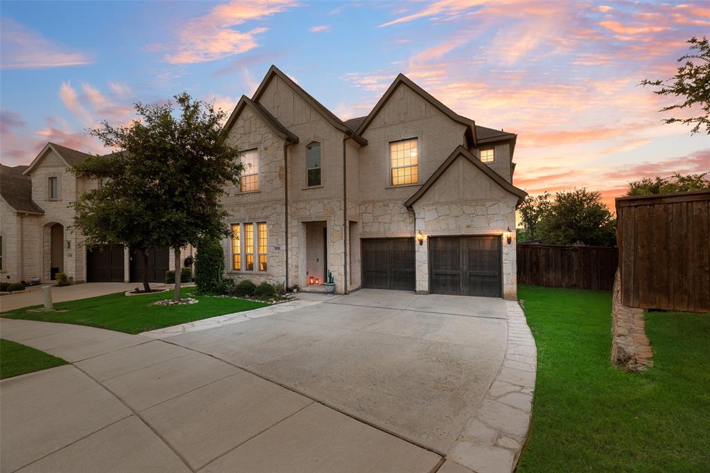 front view of a house with a yard and an trees