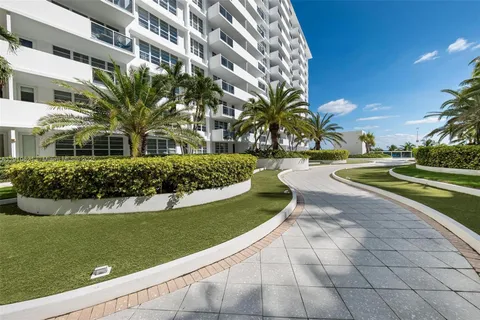 a view of a house with a yard and potted plants