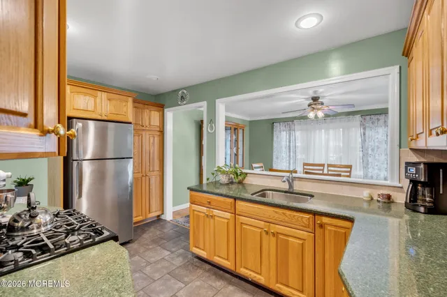 a kitchen with stainless steel appliances granite countertop a refrigerator and a sink