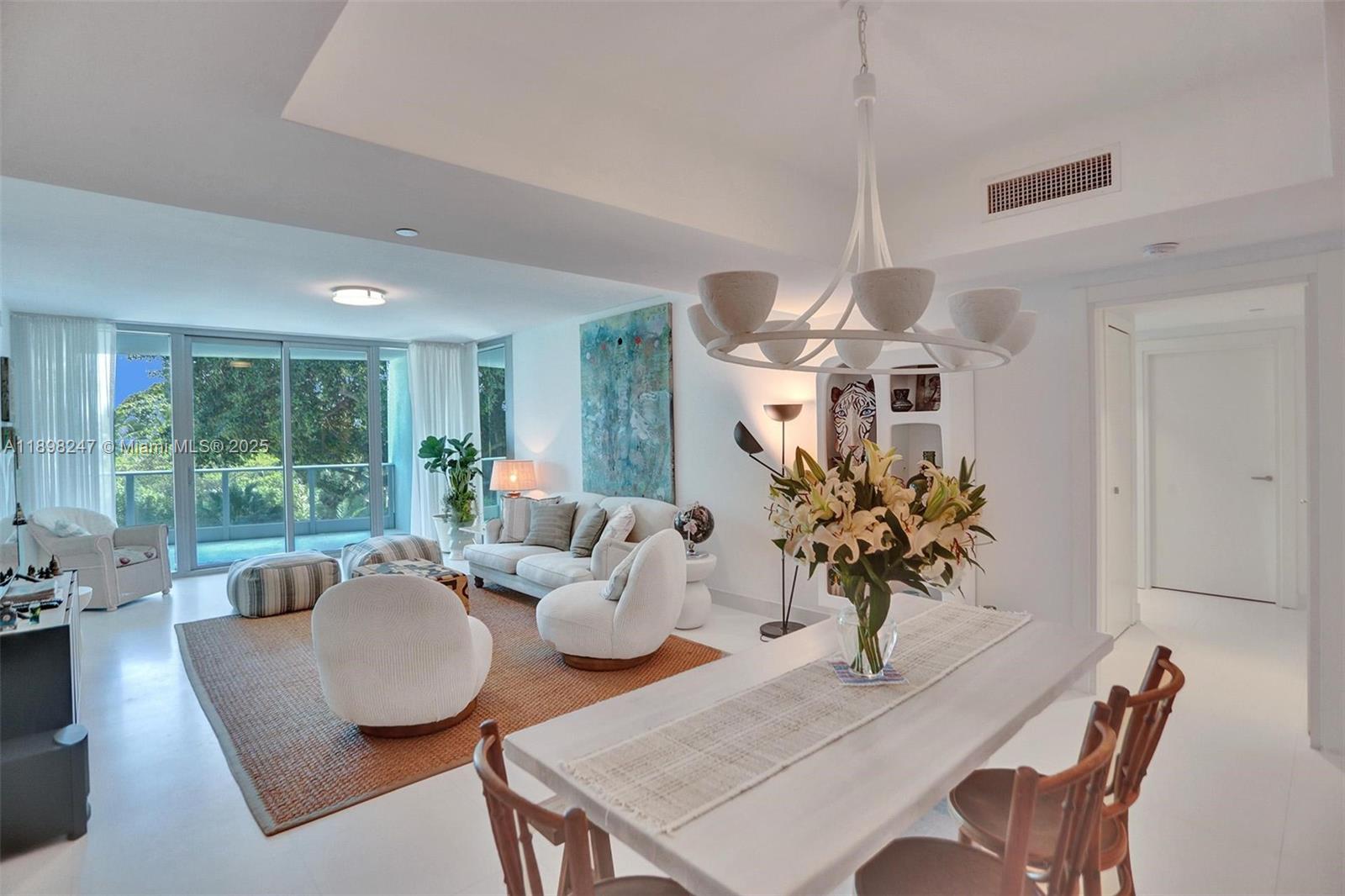 2627 South Bayshore Drive, Unit 506 Coconut Grove, FL 33133 - Photo 13 of 61 a living room with furniture kitchen view and a large window