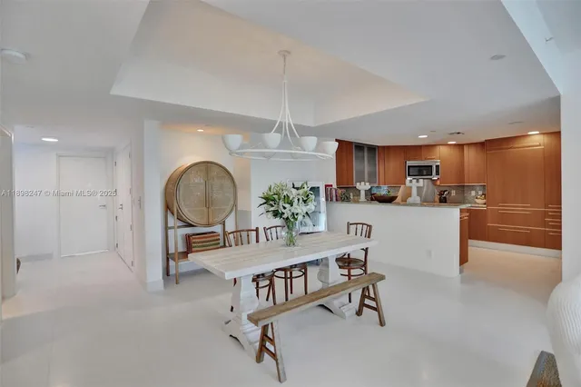 a kitchen with stainless steel appliances granite countertop a sink and a refrigerator