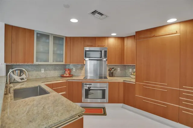a bedroom with furniture a flat screen tv and a large window