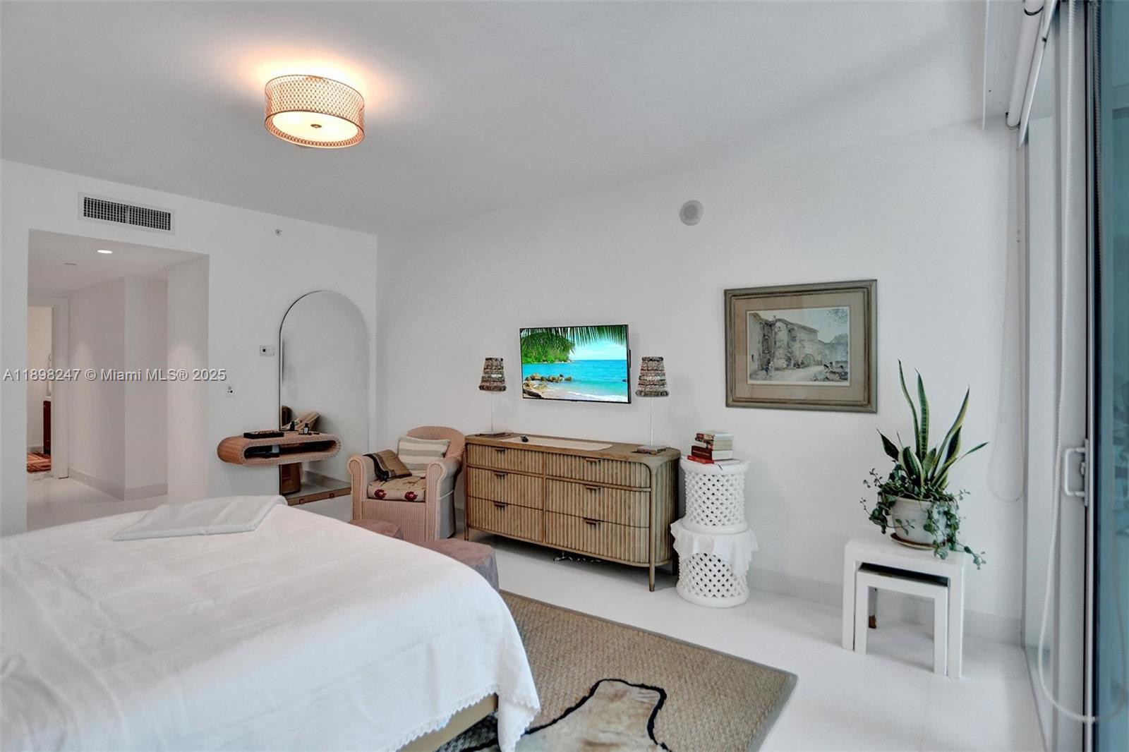 2627 South Bayshore Drive, Unit 506 Coconut Grove, FL 33133 - Photo 25 of 61 a bedroom with furniture and a chair