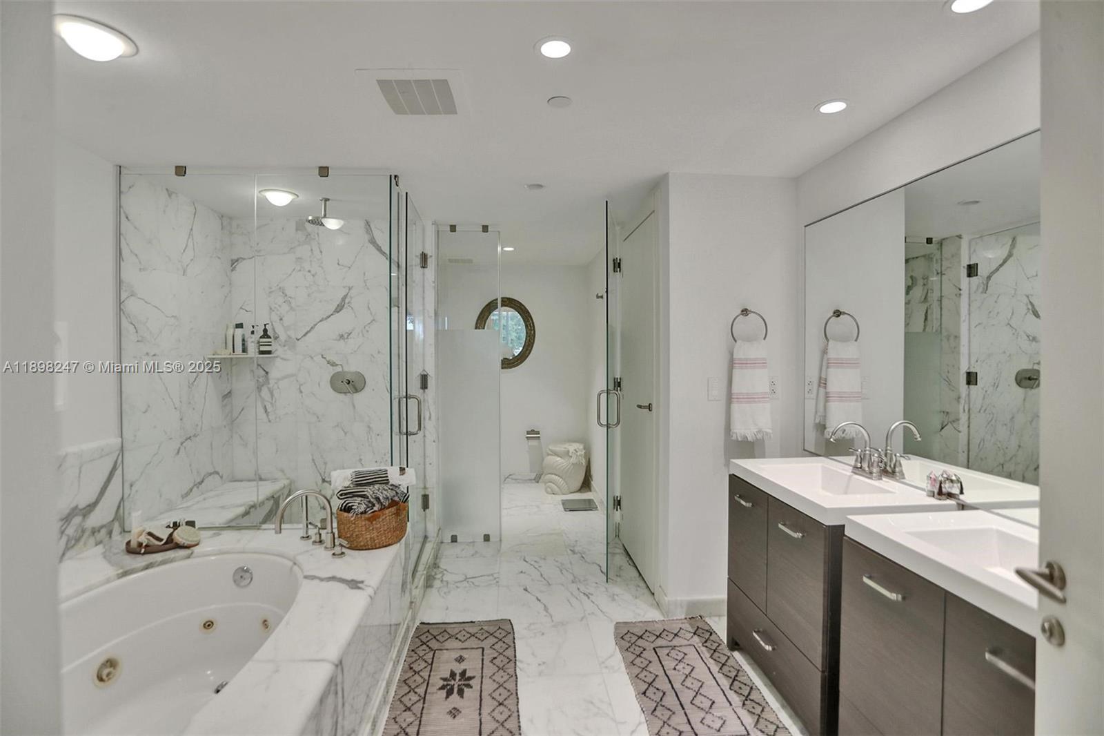 2627 South Bayshore Drive, Unit 506 Coconut Grove, FL 33133 - Photo 29 of 61 a bathroom with a double vanity sink mirror double and shower