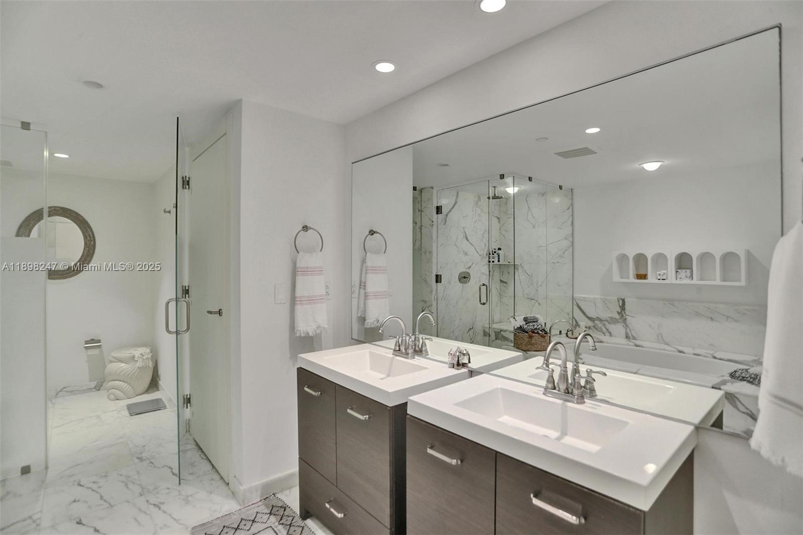 2627 South Bayshore Drive, Unit 506 Coconut Grove, FL 33133 - Photo 30 of 61 a bathroom with a sink double vanity and a shower