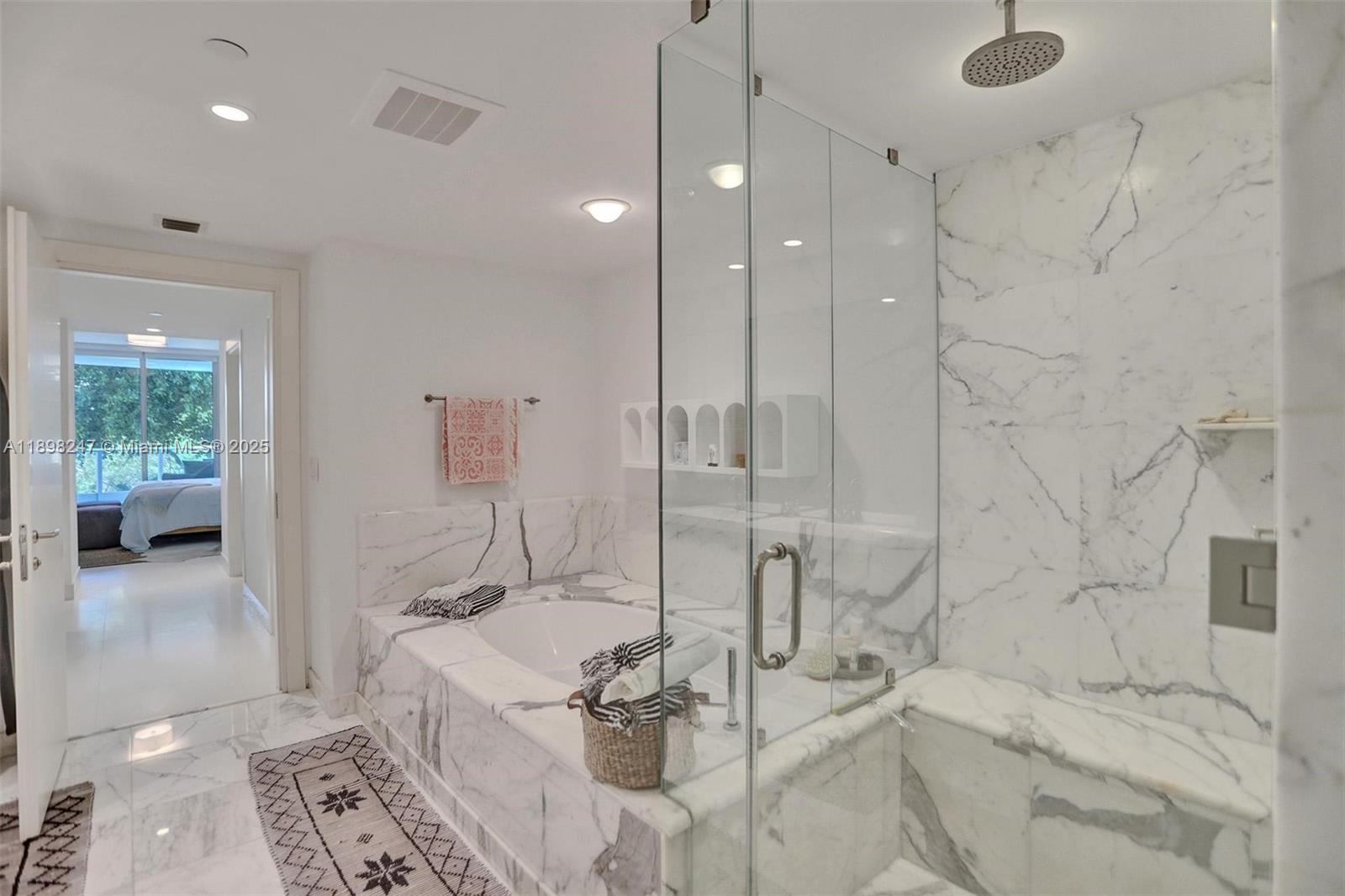 2627 South Bayshore Drive, Unit 506 Coconut Grove, FL 33133 - Photo 31 of 61 a bathroom with a tub sink and mirror