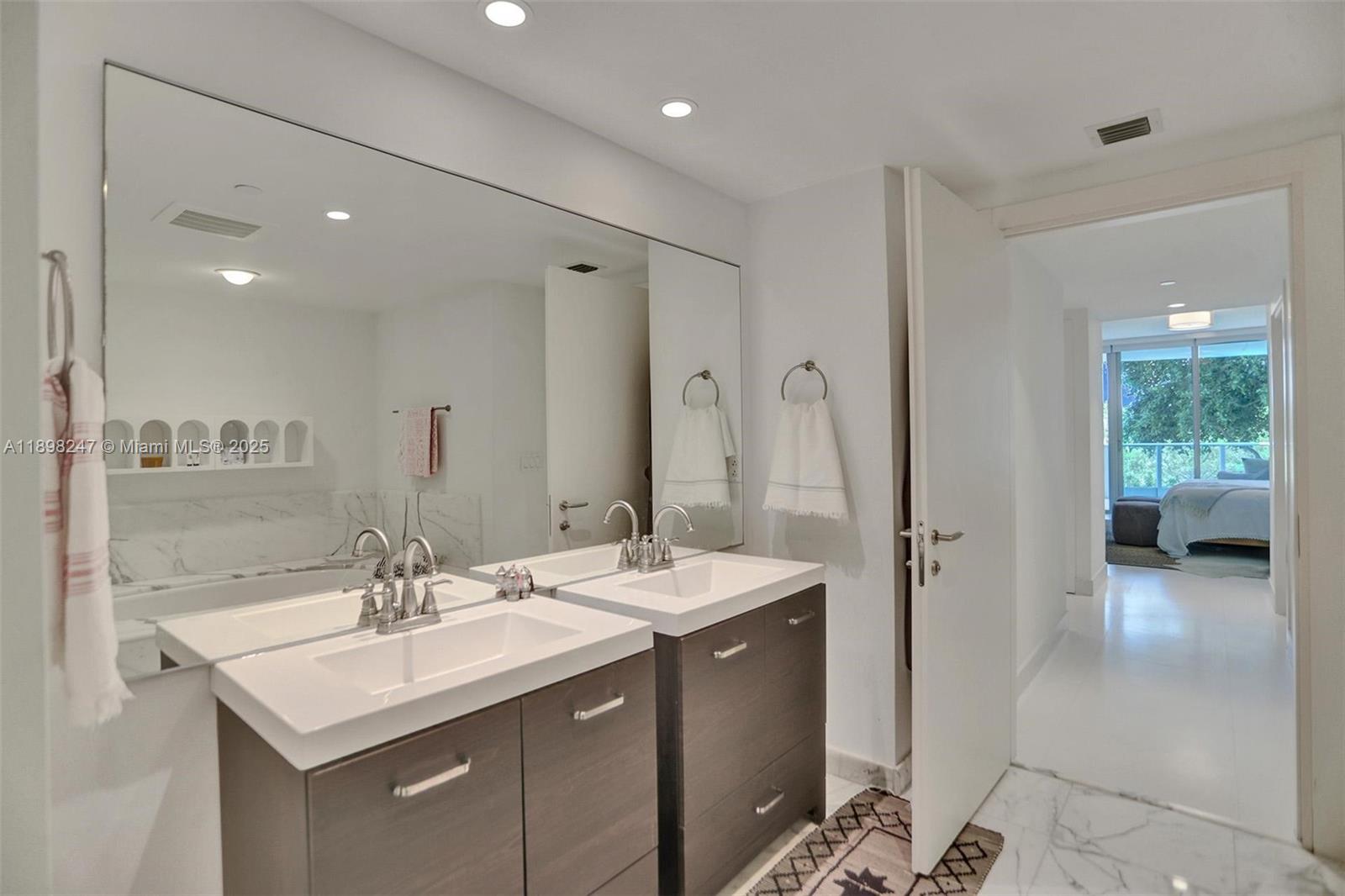 2627 South Bayshore Drive, Unit 506 Coconut Grove, FL 33133 - Photo 33 of 61 a bathroom with a sink double vanity and a mirror