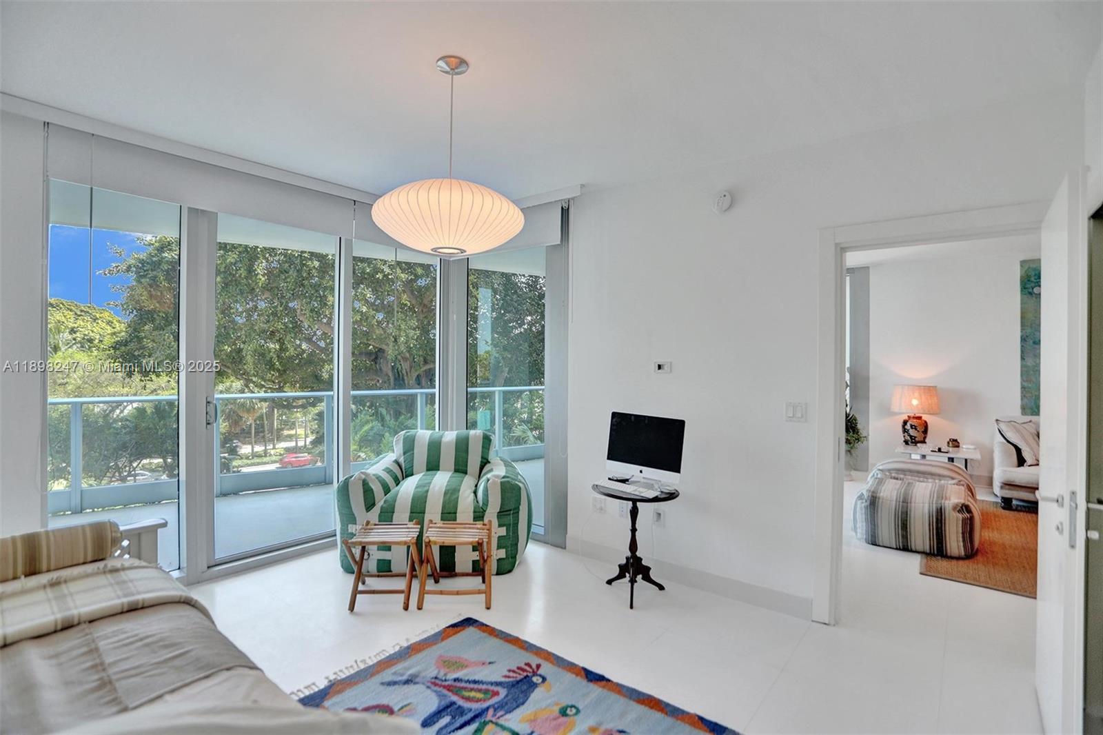 2627 South Bayshore Drive, Unit 506 Coconut Grove, FL 33133 - Photo 35 of 61 a living room with furniture and a floor to ceiling window