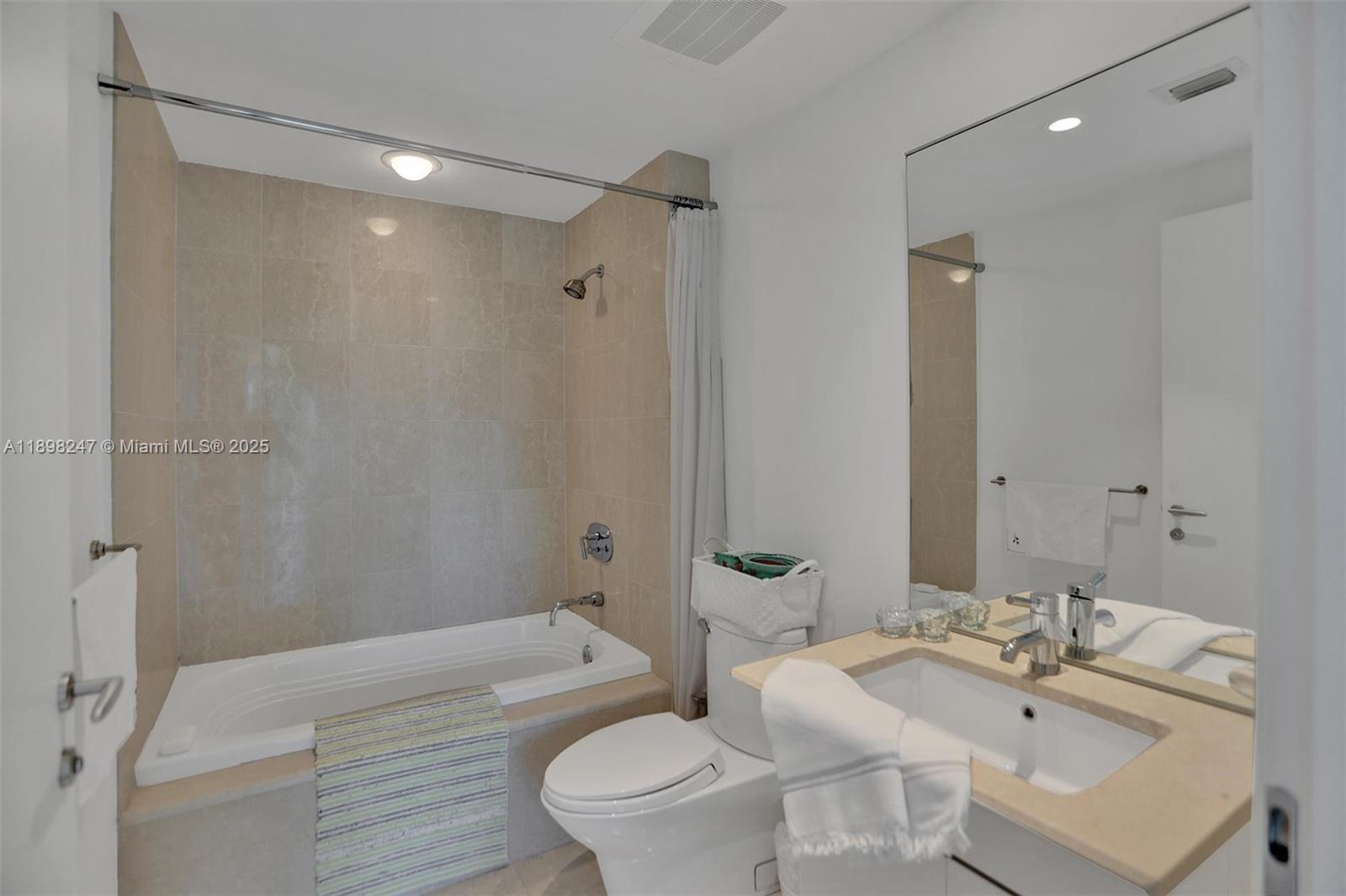 2627 South Bayshore Drive, Unit 506 Coconut Grove, FL 33133 - Photo 37 of 61 a bathroom with a sink a toilet and shower