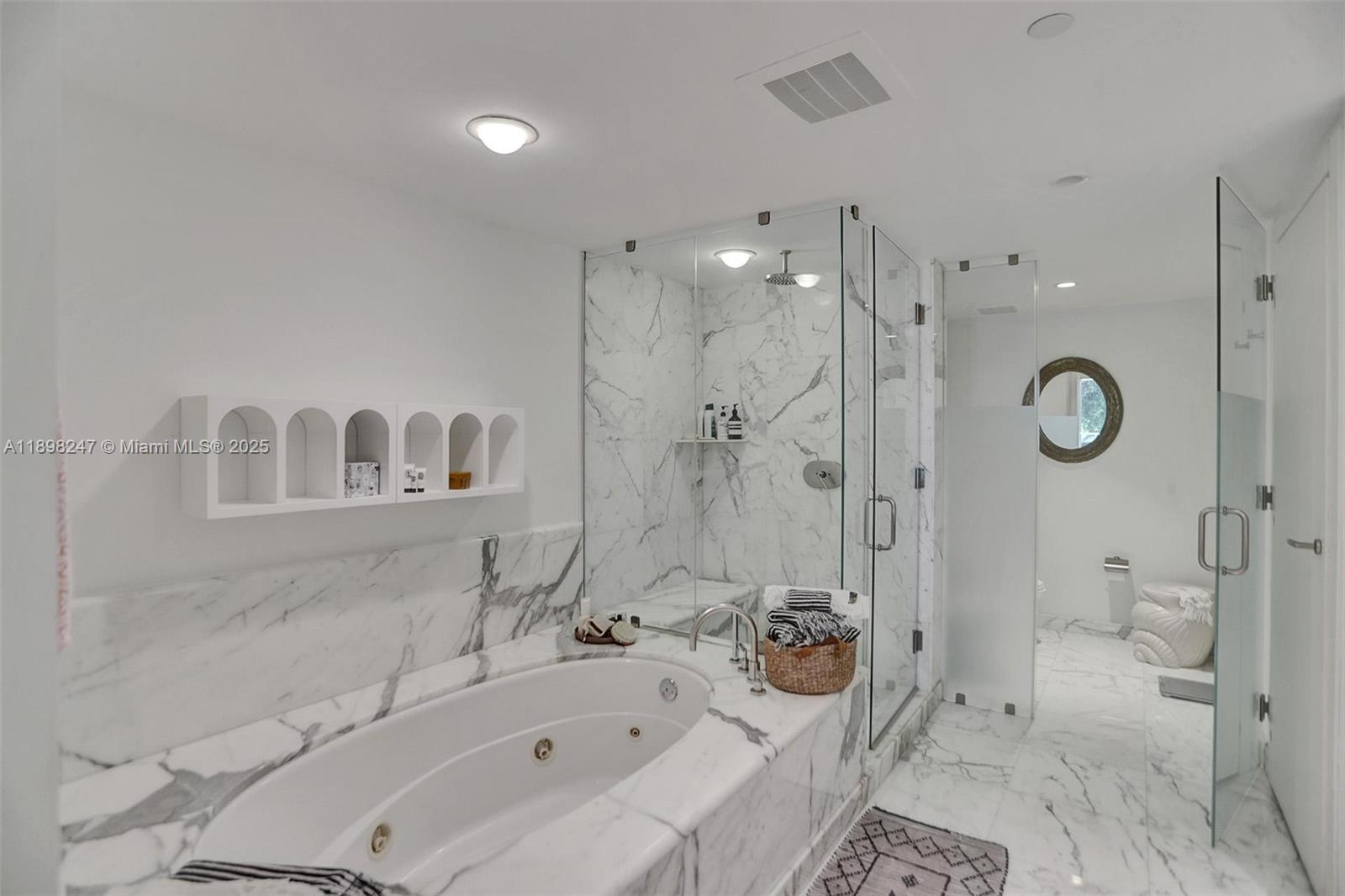 2627 South Bayshore Drive, Unit 506 Coconut Grove, FL 33133 - Photo 4 of 61 a bathroom with a bathtub shower sink mirror and toilet