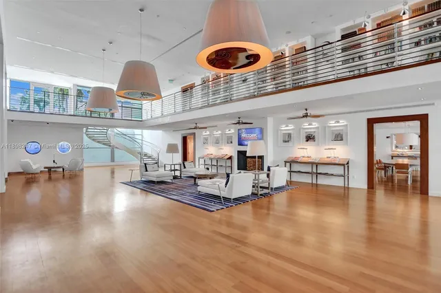 a living room with furniture a table and wooden floor