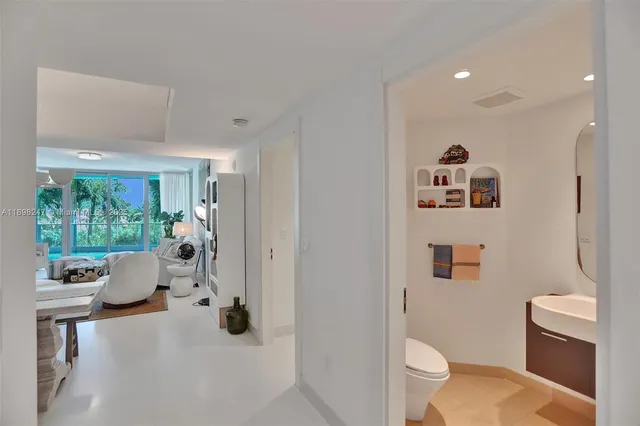 a dining room with furniture and a large window