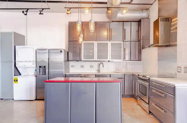 a kitchen with a sink stove and refrigerator