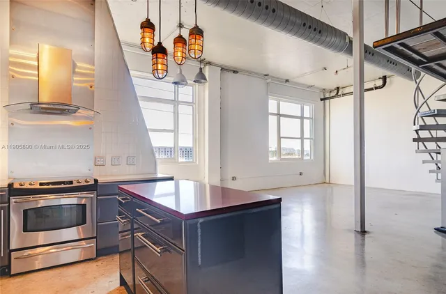 a kitchen with stainless steel appliances granite countertop a stove and a sink